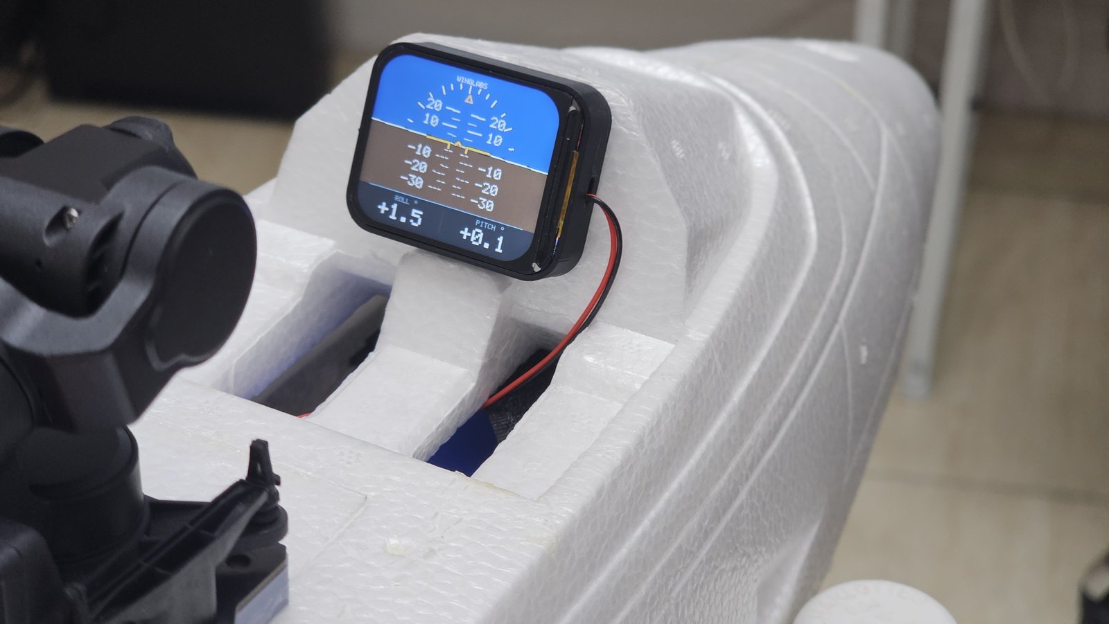 WingLabs Digital Attitude Indicator mounted in an RC aircraft cockpit